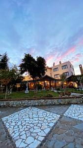 a stone walkway in front of a building at Park Ashik in Tirana