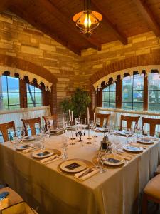 a dining room with a long table with glasses at Park Ashik in Tirana