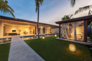 a backyard of a house with a swimming pool at One Eleven in Seminyak