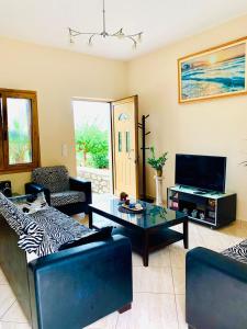 a living room with a couch and a coffee table at Sea View Three Bedroom Villa Giorgios in Gavalochori