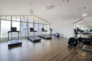 a gym with a bunch of exercise bikes in a room at UNA Serviced Apartment, Sunway Velocity Kuala Lumpur in Kuala Lumpur