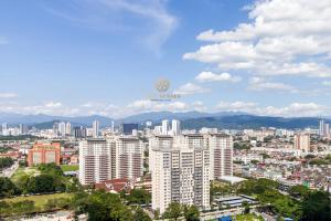 a view of a city with buildings and mountains at UNA Serviced Apartment, Sunway Velocity Kuala Lumpur in Kuala Lumpur