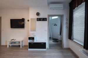 a room with a hallway with a tv and a table at Nika & Erik in Kranjska Gora