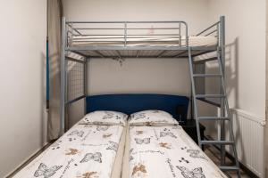 a bunk bed with a bedspread with butterflies on it at Nika & Erik in Kranjska Gora