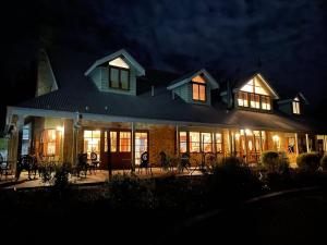 a large house at night with its lights on at Girraween Country Inn in Ballandean