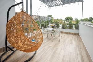 a large swing hanging from the ceiling of a room at Lâm Phong Hotel in Tây Ninh