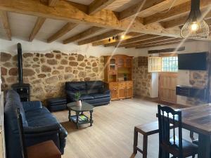 a living room with a couch and a table at Casa Rural la Marina in Las Rozas de Valdearroyo