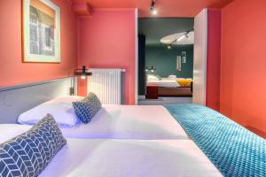 a bedroom with a large bed with orange walls at Hotel Alexander in Amsterdam