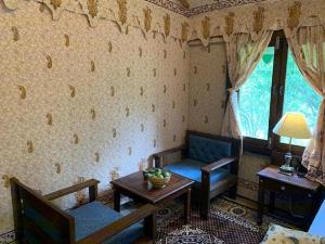 un salon avec un canapé et une table dans l'établissement EVAAN RESORTS THE FOLIAGE, à Mukteswar