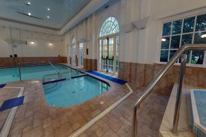 uma grande piscina interior num edifício em Village Hotel Chester St David's em Garden City