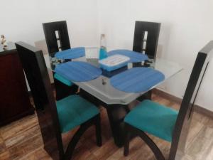 a dining room table with blue cushioned chairs around it at Casa acogedora en Santa Rosa de Cabal in Santa Rosa de Cabal