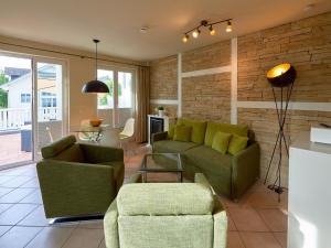 a living room with two green couches and a table at Wohnpark Stadt Hamburg - Apt. 47 in Binz
