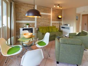 a living room with a glass table and chairs at Wohnpark Stadt Hamburg - Apt. 47 in Binz