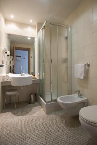 a bathroom with a shower and a sink and a toilet at Hotel Langhe in Alba