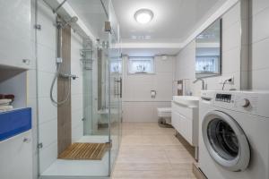 a bathroom with a washing machine and a shower at Nice Private Apartment in Hannover