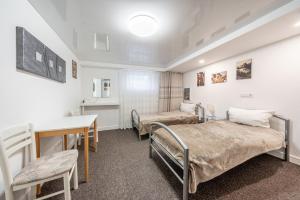 a hospital room with two beds and a desk at Nice Private Apartment in Hannover