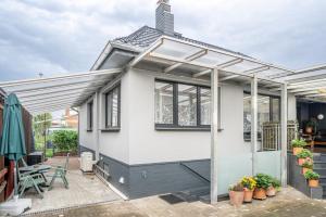 a house with awning and a patio at Nice Private Apartment in Hannover