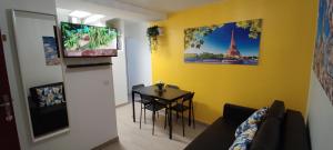 a living room with a table and a dining room at Promotion du jour - L'Olivier - in Deuil-la-Barre