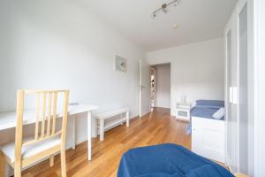 a bedroom with a desk and a bed in a room at Private Rooms in Hannover