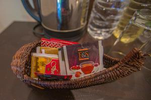 a basket filled with books on a table at Avenra Cottage in Ella