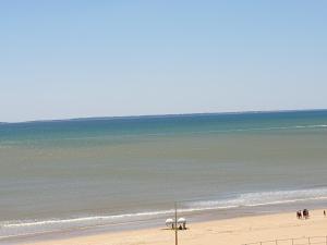 una playa con gente de pie en la arena y el océano en Studio alcôve, vue mer, 4 personnes, Saint Jean de Monts, en Saint-Jean-de-Monts 18 fotos más