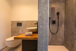 a bathroom with a sink and a toilet and a shower at Modul Häuser Maurer in Georgenberg