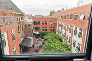 a view from a window of a city with buildings at Hotel The Happy Traveler in Groningen