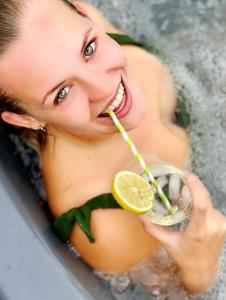 a woman brushing her teeth while drinking a drink at Buddhas Bed & Wellness - B&B - FEEL GOOD FOOD - kreativ - gesund - vegan 