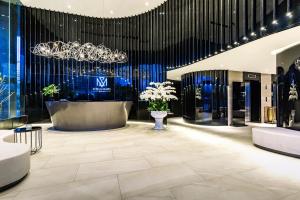 a lobby of a luxury store with a chandelier at Stella Maris Beach Danang in Da Nang