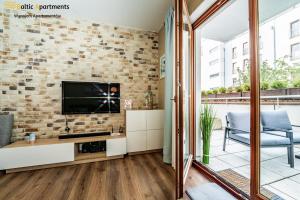 Telewizja i/lub zestaw kina domowego w obiekcie Baltic Apartments - Portofino