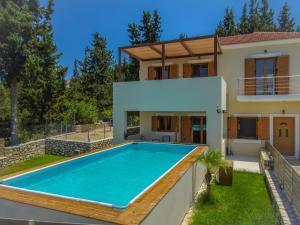a swimming pool in the backyard of a house at Sea View Two Bedroom Villa Giorgios in Gavalochori