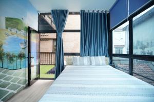 a bedroom with a large bed and large windows at 5 to 10 bedrooms houses in Ha Long