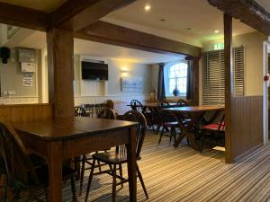 a dining room with wooden tables and chairs at The Silverton Inn in Silverton