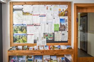 a large bulletin board with many papers on it at Lisas - with Wellness and Breakfast in Schröcken