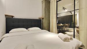 a bedroom with a large bed and a dining room at New Gudauri Atrium 139 in Gudauri