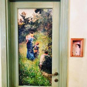 a painting of a woman holding a child on a door at AL CASALE SANT' ANNA PELAGO in SantʼAnna Pelago