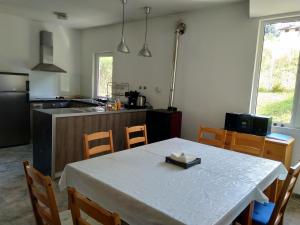 a kitchen with a table and chairs and a kitchen with a counter at VILLA IRINA - Govedartsi in Govedartsi