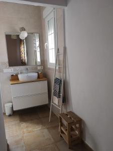 a bathroom with a sink and a mirror at Botavara in El Cabo de Gata