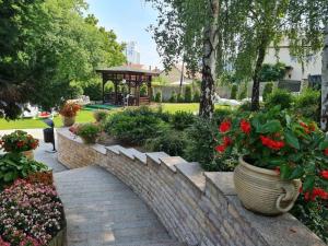 a garden with a gazebo in a park at Spa Residence Carbona Aloe Lux Apartman Hévíz in Hévíz