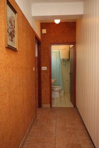 a hallway with a bathroom with a toilet and a sink at Apartments by the sea Metajna, Pag - 6352 in Metajna