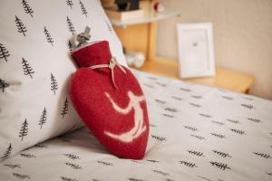 a red sock sitting on top of a bed at Panoram'Alp in Savièse