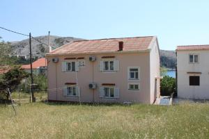 a house in the middle of a field at Rooms by the sea Metajna, Pag - 6378 in Metajna