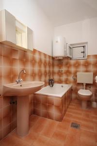a bathroom with a sink and a toilet at Rooms by the sea Metajna, Pag - 6378 in Metajna