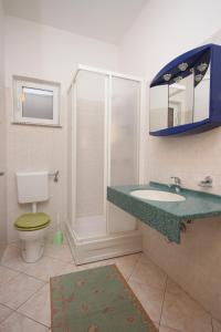a bathroom with a sink and a toilet and a mirror at Apartments by the sea Jakisnica, Pag - 6274 in Lun +46 photos