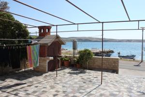 a house with a towel hanging from a clothes line at Rooms by the sea Kustici, Pag - 6288 in Kustići