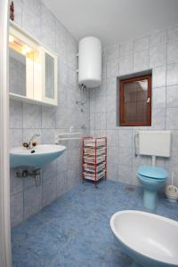 a bathroom with a sink and a toilet at Rooms by the sea Kustici, Pag - 6288 in Kustići