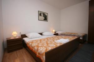 スタラ・ノヴァリャにあるApartments by the sea Stara Novalja, Pag - 6301のベッド2台とランプ2台があるホテルの部屋