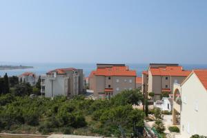 a city with houses and the ocean in the background at Apartments and rooms with parking space Novalja, Pag - 6341 in Novalja