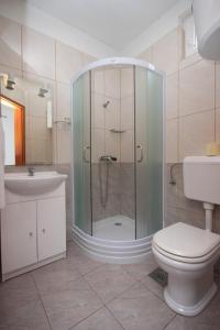 a bathroom with a shower and a toilet and a sink at Apartments and rooms with parking space Novalja, Pag - 6341 in Novalja +49 photos