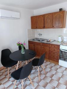 a kitchen with a table and chairs and a counter at Apartments with parking space Pag - 6325 in Pag +32 photos